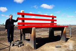 The Big Bench seat is 2.5 times higher than a normal bench seat and rests at the Lode Lookout giving panoramic views of Broken Hill in NSW.